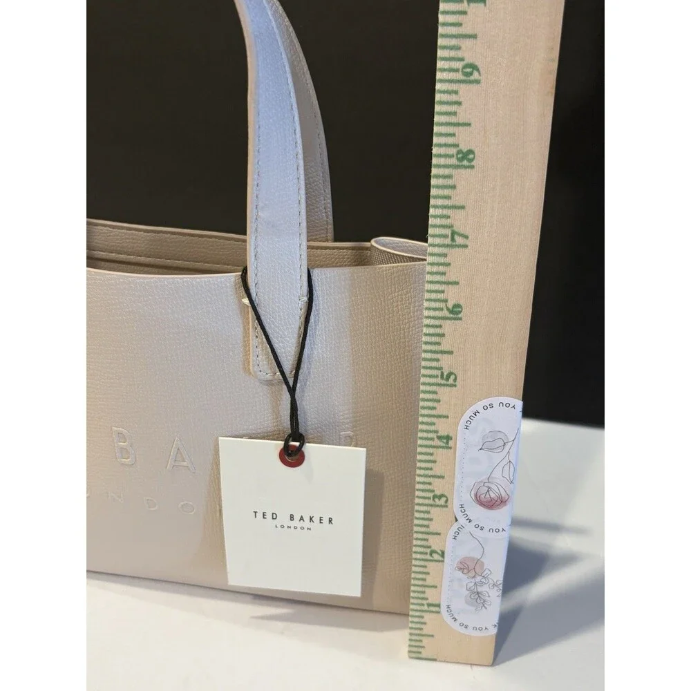 Ted Baker Icon small tote bag in a cream-colored, structured material.